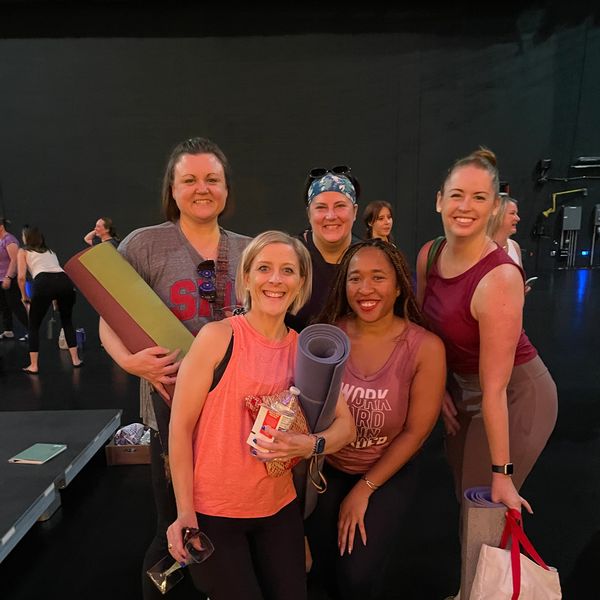 Coach Lori B. connecting with her students after teaching a yoga experience. 