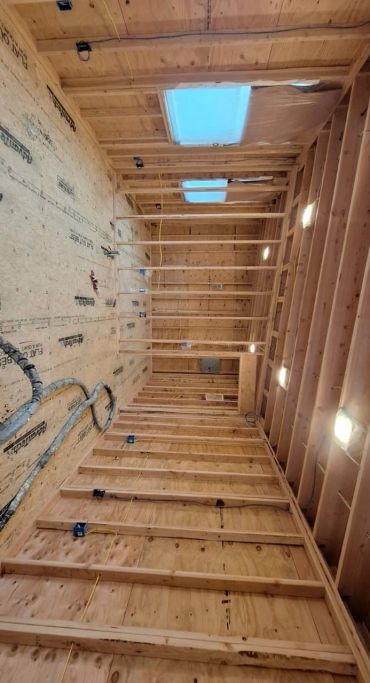 Interior frame of a wooden building under construction.