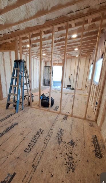 Interior construction with wooden framing and insulation.