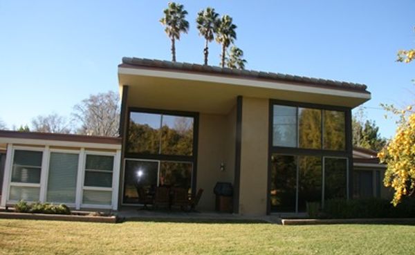 Modern house with large windows and palms