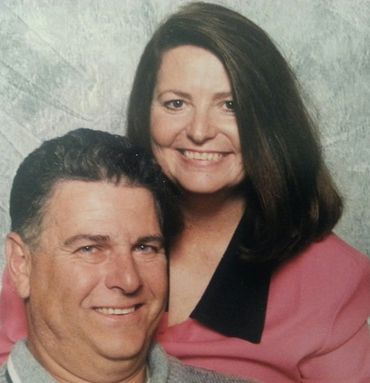 Smiling middle-aged couple posing