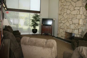 Living room with recliner and stone wall