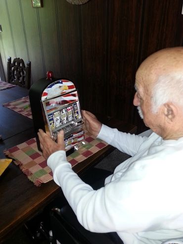 Senior man playing a tabletop slot machine