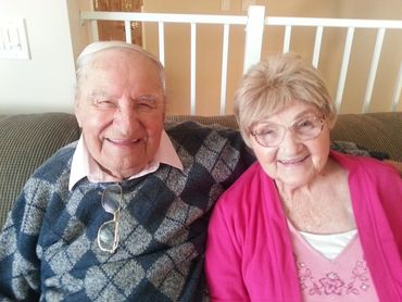 Senior couple sitting together on a couch