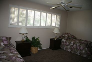Bedroom with white shutters and lamps