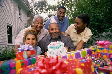 Family celebrating birthday with cake