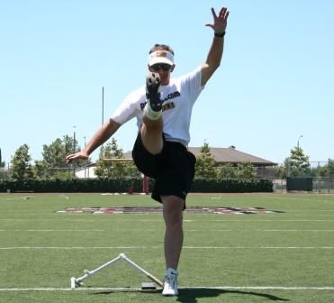 Ken Olson using straight on technique follow throught wearing football square toe kicking shoe
