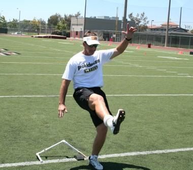 Ken Olson kicking straight on style post kick wearing square toe football kicking shoe