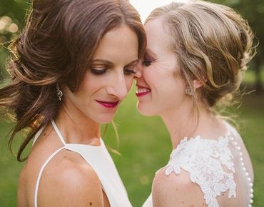 Two brides smiling