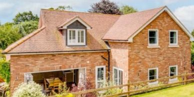 A charming brick house with a well-kept garden.