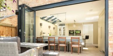Open kitchen with bar stools and outdoor seating.