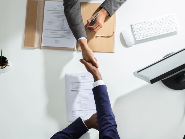 A recruiter greeting a candidate to an interview