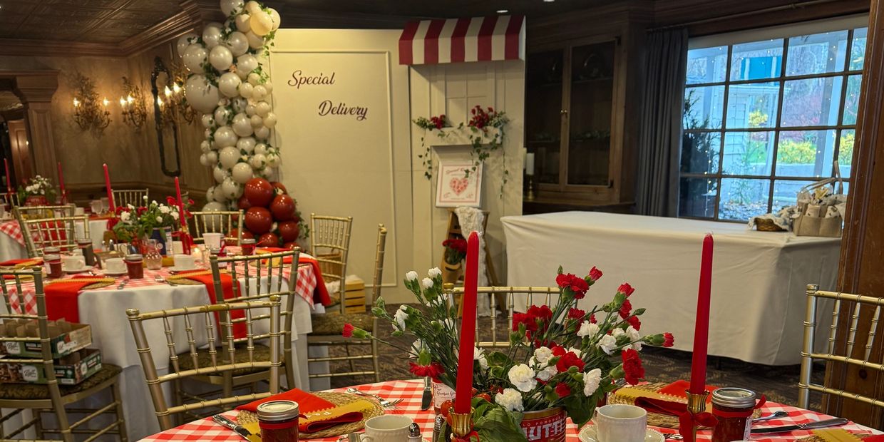 Elegant checkered red and white table setting with personalized name tags and floral centerpiece.