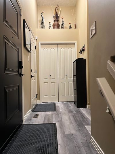 Neatly organized hallway with decorative giraffe figurines and neutral tones.