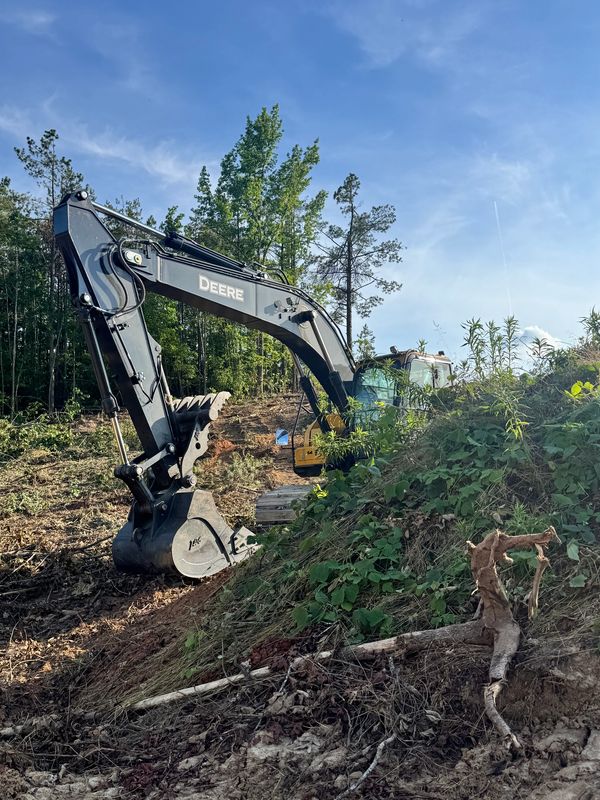 John Deere excavator clearing for phase VII of Taylor Greene. 