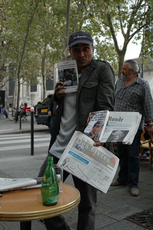 Paris, St. Sulpice, man selling newspapers