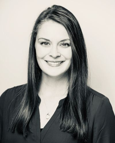Dr. Emily Bryant, of Mountain West Eye Care, wearing a black scrub in front of a white background.