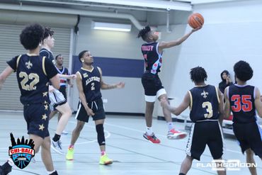Basketball player jumps for a shot during a competitive game indoors.