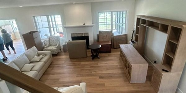 Living room with furniture and unpacked boxes.