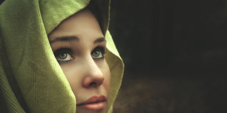 Close-up of a vibrant green eye, representing Archangel Raphael's emerald light