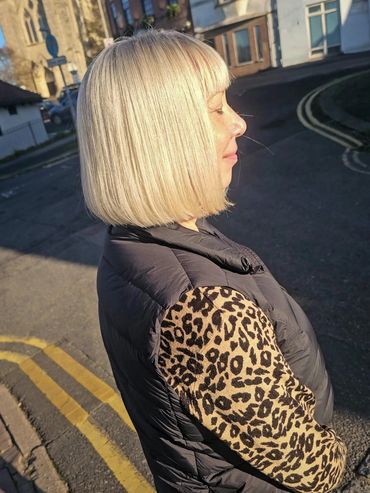 ChatGPT said:

Bright icy blonde bob with fringe, captured in natural sunlight after a fresh cut and