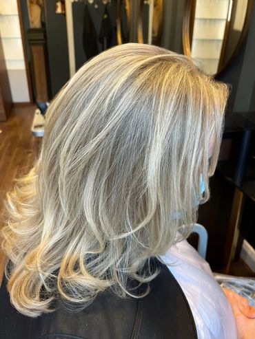 Soft blonde highlights with layered mid-length cut styled at Santoro Hair Salon in Brighton. The sub