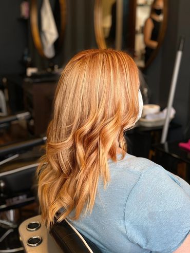 Soft copper balayage with loose waves created at Santoro Hair Salon in Brighton. The warm golden ton