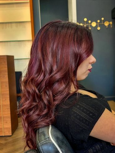 Rich burgundy balayage hair with soft curls styled at Santoro Hair Salon in Brighton.  
