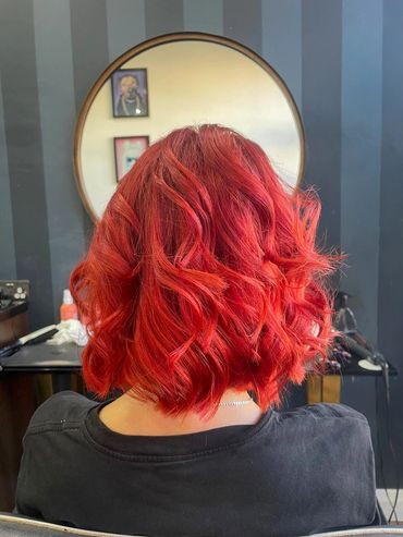 ChatGPT said:

Vibrant cherry red bob with soft waves, styled at Santoro Hair Salon in Brighton.