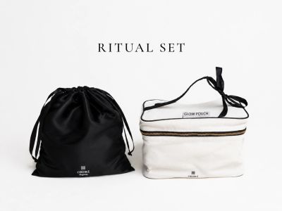 Minimalist ritual set with a black drawstring bag and a white glow pouch.