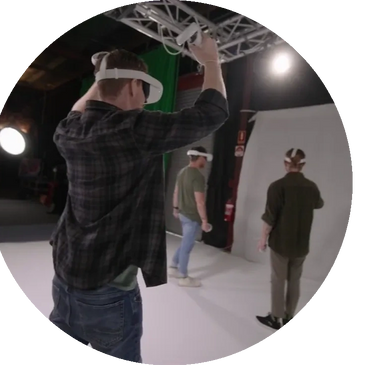 Three men using VR headsets in a studio setting.