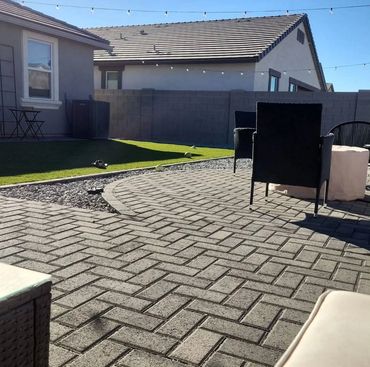 backyard landscape with pavers, retaining wall and turf in Arizona 