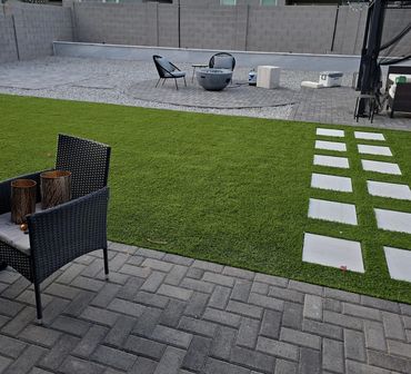 backyard landscape with pavers, retaining wall and turf in Arizona 