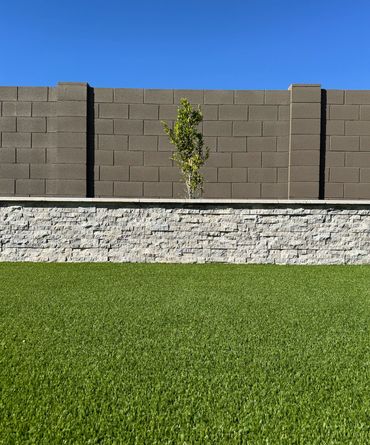 backyard landscape with retaining wall and turf in Arizona 
