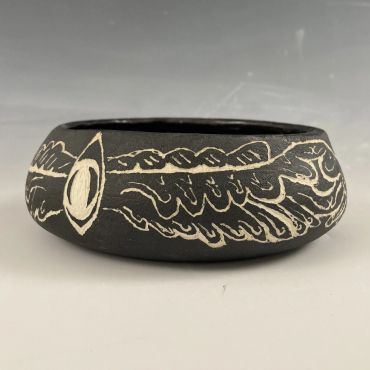 Black pottery with white incised designs.