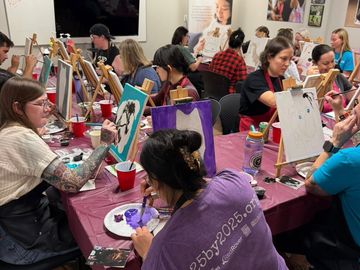Group painting class with concentrated participants.