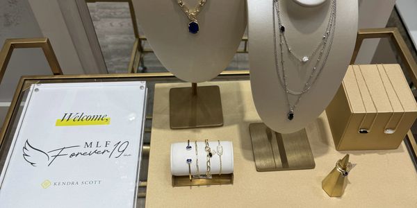 Elegant jewelry display with necklaces, bracelets, and rings from Kendra Scott.