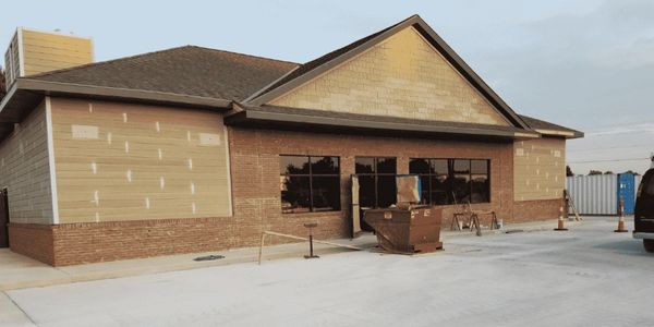 New convenience store, Tennessee construction with fresh concrete, safety tape, dumpster, mason work