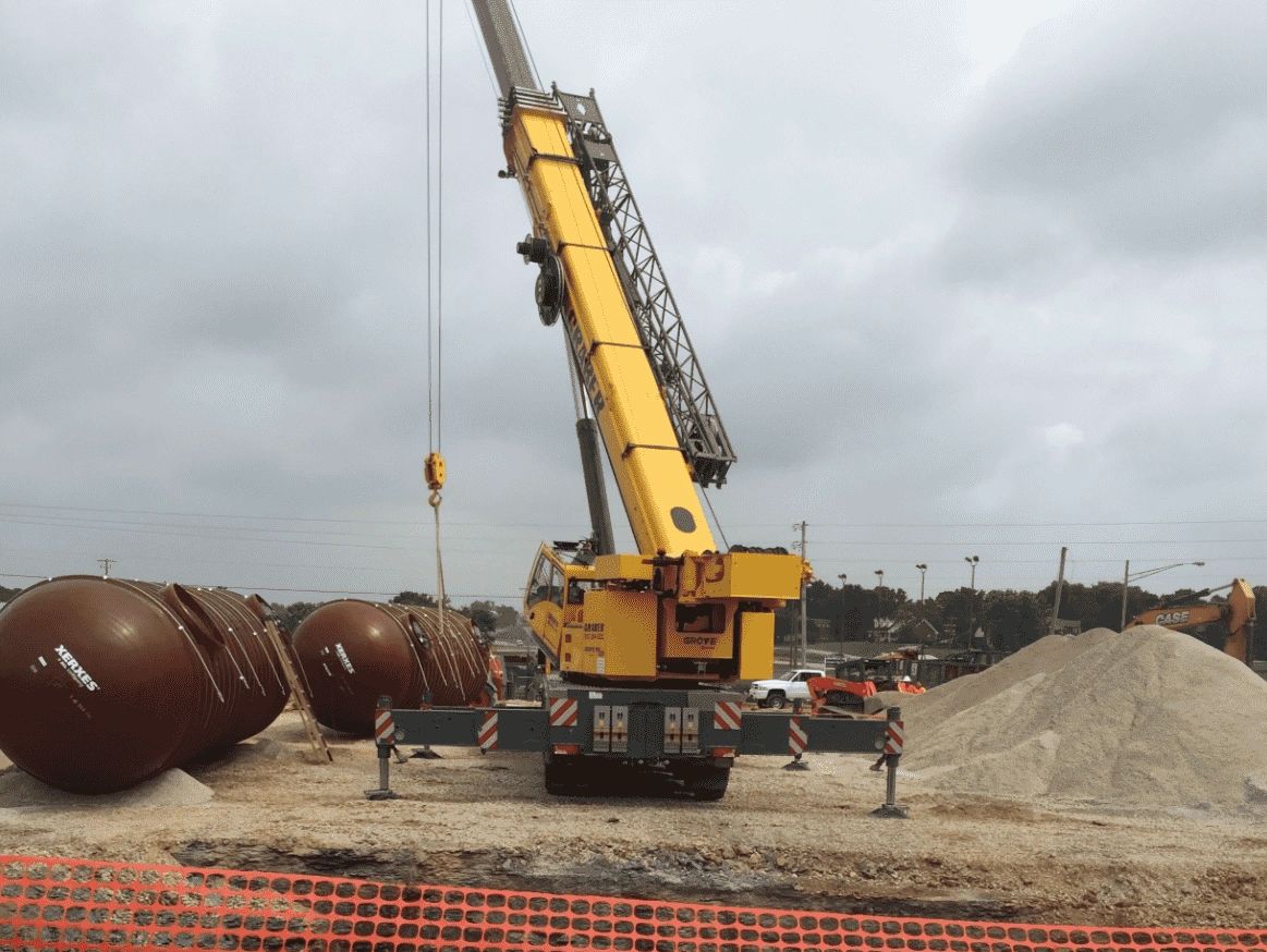 Large crane lifting gas tanks during a commercial construction project, general contractors Kentucky