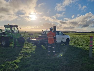 sunset with engineer in foreground testing driven pile