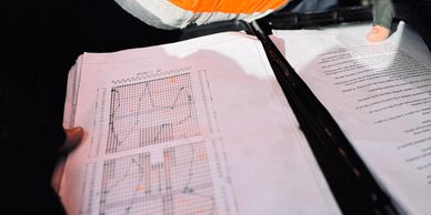 EMRO engineer reviewing site plans and documentation at solar construction zone