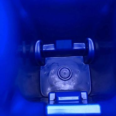 Inside view of a blue container with a cylindrical object.
