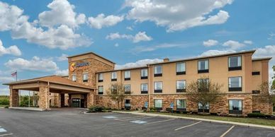Exterior view of a modern hotel building under a blue sky.