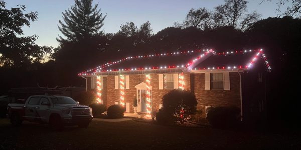 House decorated with Christmas lights at dusk.