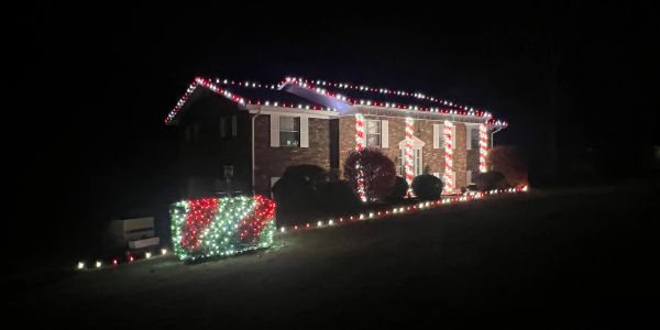 House decorated with Christmas lights at night.