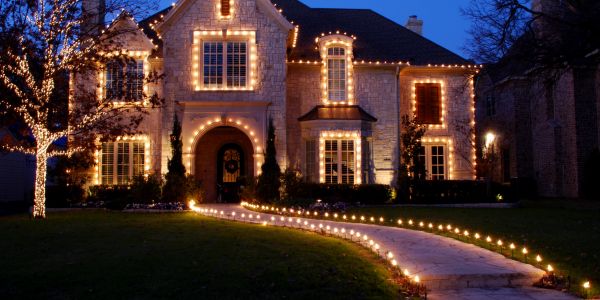 Large house decorated with warm yellow lights.