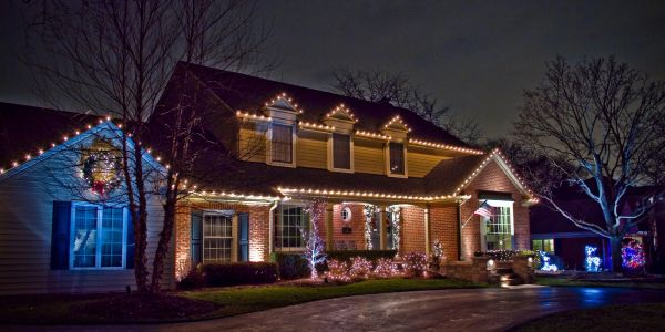 House decorated with Christmas lights at night.