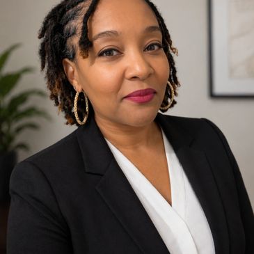 Confident professional woman in black blazer and white blouse.