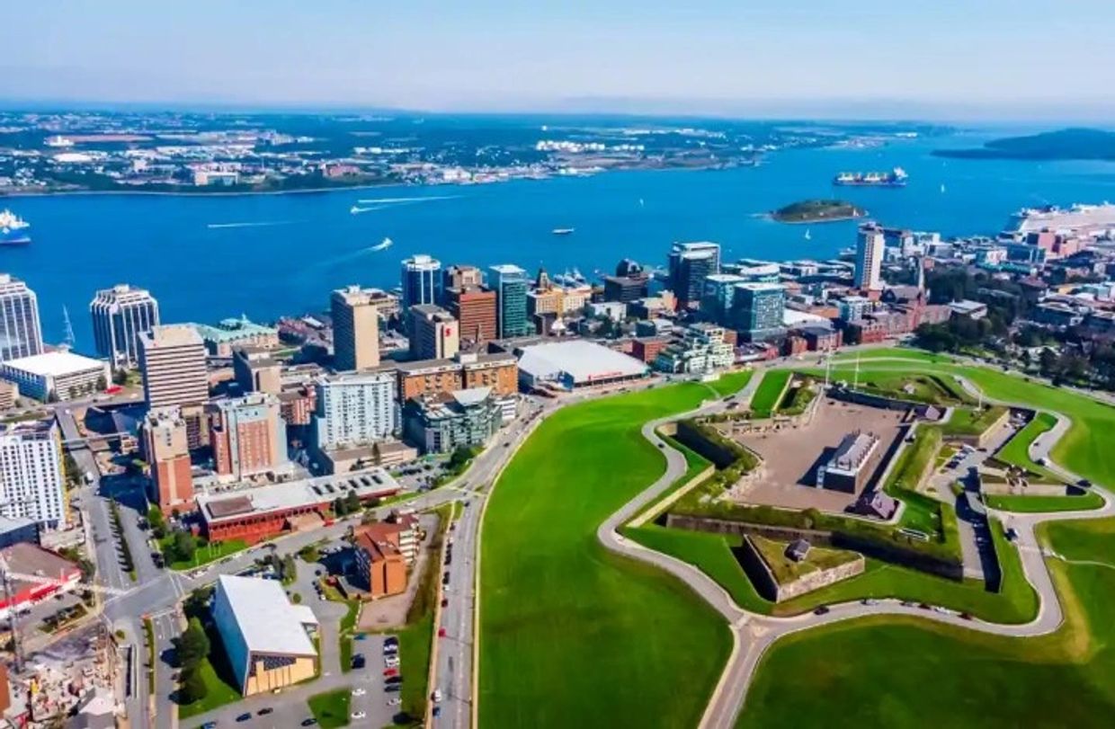 Aerial view of a star-shaped fort near a coastal city.