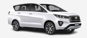 White Toyota Innova parked, side view.